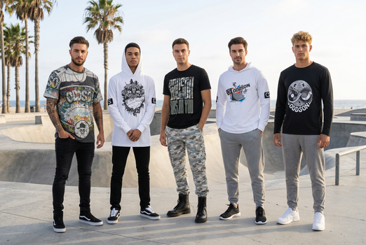 Five models together at a coastal skate park