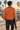 Back view: male model at coastal skatepark, facing away