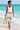 Barefoot beach look with ivory sleeveless top