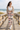 Beach boardwalk editorial with white sports bra and sand jacket