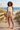 Beach boardwalk with an ivory sleeveless top