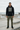Black hoodie with olive cargo trousers at a skatepark