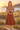 Blonde model wearing the terracotta geometric midi dress at golden hour
