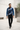 Blue quarter-zip in a modern architectural courtyard