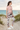 Blush tee and leggings along beach dunes