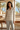Botanical pajama top styled with pale gray trousers