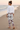 Bun-haired model, shoreline rear-angle look