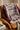 Burgundy sweater draped over leather