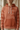 Close-up of the rust hoodie’s mountain-patterned chest