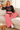 Cozy sofa look with coral-pink trousers