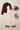 Cream bordered pants styled with a cropped blazer