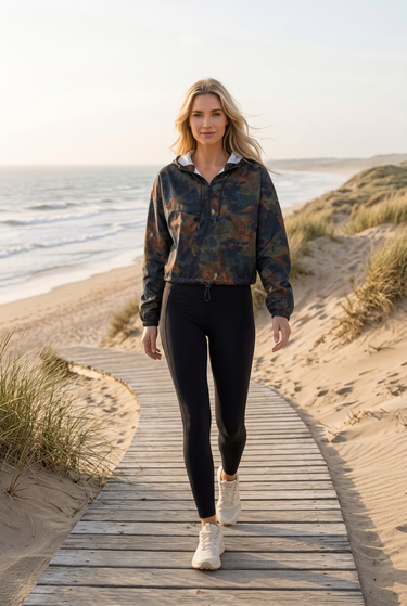 Cropped windbreaker with black leggings on coastal dunes