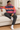 Curly-haired male model relaxing on a sofa in charcoal joggers