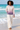 Female barefoot beach look with cream linen trousers