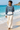 Female beach look with cream linen trousers