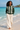 Female beach look with cream linen trousers