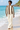 Female beach look with cream linen trousers
