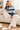 Female cozy sofa look with cream trousers