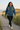 Female hoodie editorial on coastal boardwalk