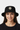 Female model close-up wearing black bucket hat smiling