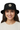 Female model close-up wearing black bucket hat