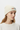 Female model close-up wearing ecru cream beanie looking to side