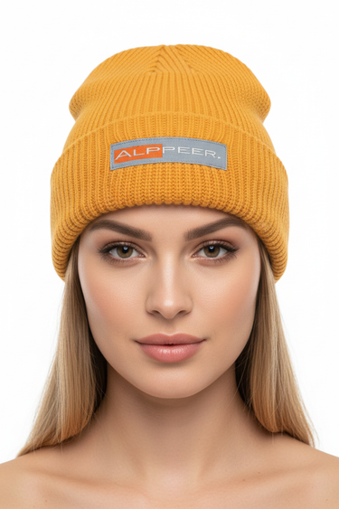 Female model close-up wearing gold beanie