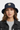 Female model close-up wearing navy bucket hat