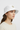 Female model close-up wearing white bucket hat looking to side