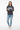 Female model in charcoal melange sweatshirt with light wash denim jeans