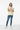 Female model in denim jeans and white sneakers