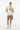 Female model in khaki shorts and white sneakers