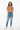 Female model in mauve tee with light wash denim jeans