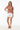 Female model in mauve tee with white denim shorts