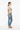 Female model in oatmeal tee with light wash jeans