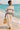Female model in sweatshirt and sand linen trousers