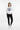 Female model in white crewneck with black athletic leggings