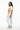 Female model in white joggers and tan sneakers