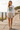 Female model in white mountain graphic tee and sand shorts