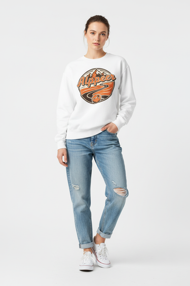 Female model in white sweatshirt with light wash denim jeans