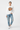 Female model in white sweatshirt with light wash denim jeans