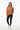 Female model in yam orange sweatshirt with black leggings