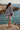Female model showcasing the sweatshirt back with boardshorts