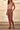 Female model styling the joggers with a blush satin camisole