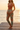 Female model styling the joggers with a terracotta bodysuit