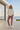 Female model styling the joggers with an oversized cream sweatshirt