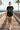 Female model wearing black graphic tee and boardshorts