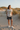 Female model wearing sand graphic tee and boardshorts