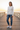 Female model wearing the floral sweatshirt with distressed blue jeans
