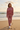 Female model wearing the matching Rose Mist sweatshirt and joggers on the beach